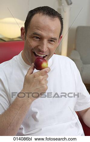 young man biting into red apple View Large Photo Image Stock Image - young man biting into red apple. Fotosearch