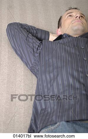 young man lying on floor day-dreaming View Large Photo Image Stock Image - young man lying on floor day-dreaming. Fotosearch