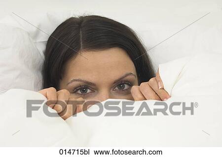 young woman hiding in bed behind duvet View Large Photo Image Stock Image - young woman hiding in bed behind duvet. Fotosearch