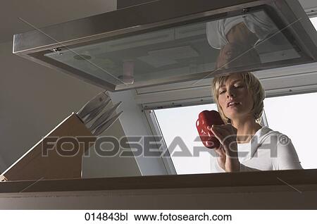 young woman in kitchen checking red pepper View Large Photo Image Stock Image - young woman in kitchen checking red pepper. Fotosearch