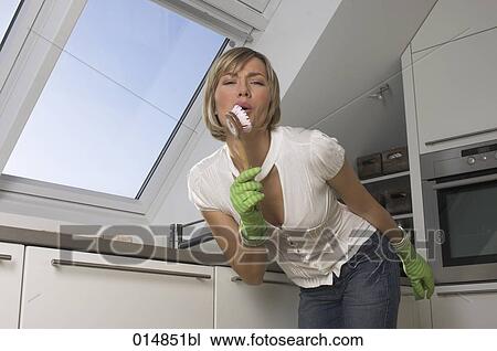 young woman in kitchen having fun while washing up View Large Photo Image Stock Image - young woman in kitchen having fun while washing up. Fotosearch