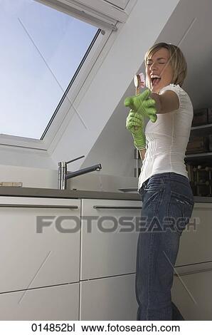 young woman in kitchen having fun while washing up View Large Photo Image Stock Image - young woman in kitchen having fun while washing up. Fotosearch