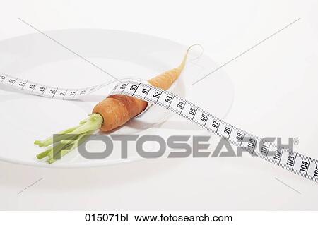 carrot on plate with tape measure View Large Photo Image Stock Image - carrot on plate with tape measure. Fotosearch