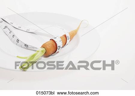 carrot on plate with tape measure View Large Photo Image Stock Image - carrot on plate with tape measure. Fotosearch