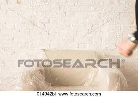 empty armchair wrapped in plastic standing in front of wall View Large Photo Image Stock Image - empty armchair wrapped in plastic standing in front of wall. Fotosearch