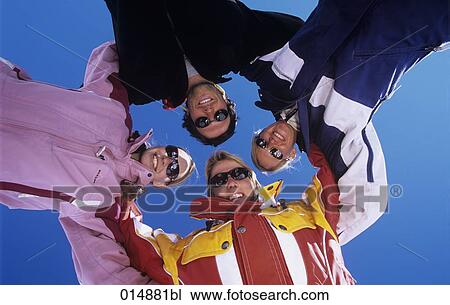 group of four friends in winter clothes holding each other View Large Photo Image Stock Image - group of four friends in winter clothes holding each other. Fotosearch