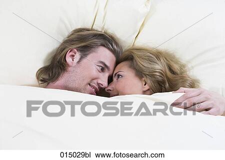 headshot of couple lying in bed happily looking at each other View Large Photo Image Stock Image - headshot of couple lying in bed happily looking at each other. Fotosearch