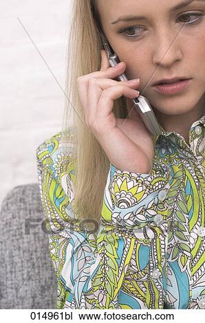 headshot of worried young woman talking on cellphone View Large Photo Image Stock Image - headshot of worried young woman talking on cellphone. Fotosearch