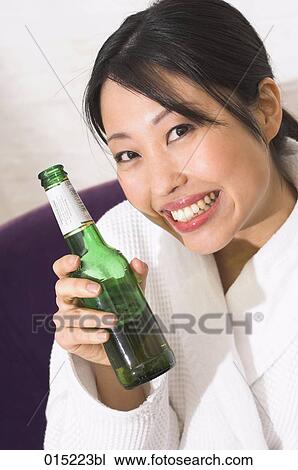 headshot of young japanese woman holding beer bottle View Large Photo Image Stock Image - headshot of young japanese woman holding beer bottle. Fotosearch