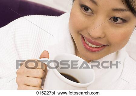 headshot of young japanese woman drinking some coffee View Large Photo Image Stock Image - headshot of young japanese woman drinking some coffee. Fotosearch