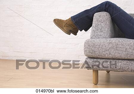 legs of woman taking a rest on armchair View Large Photo Image Stock Image - legs of woman taking a rest on armchair. Fotosearch