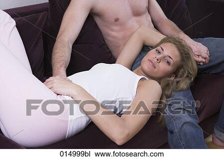 pensive young woman lying on sofa with head on lap of man View Large Photo Image Stock Image - pensive young woman lying on sofa with head on lap of man. Fotosearch