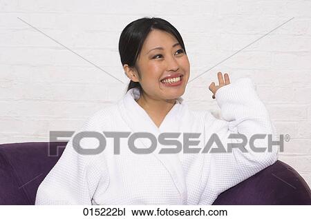 portrait of happy japanese woman in bathrobe sitting in purple arm chair View Large Photo Image Stock Image - portrait of happy japanese woman in bathrobe sitting in purple arm chair. Fotosearch