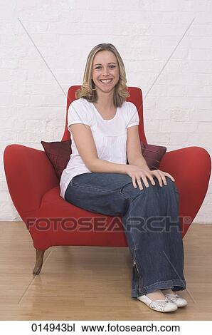 portrait of smiling young woman sitting in red armchair View Large Photo Image Stock Image - portrait of smiling young woman sitting in red armchair. Fotosearch