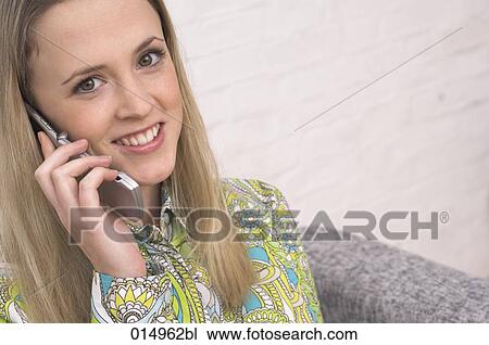 portrait of smiling young woman talking on cellphone View Large Photo Image Stock Image - portrait of smiling young woman talking on cellphone. Fotosearch