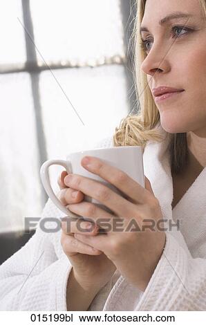 portrait of thoughtful young woman in bathrobe holding mug View Large Photo Image Stock Image - portrait of thoughtful young woman in bathrobe holding mug. Fotosearch