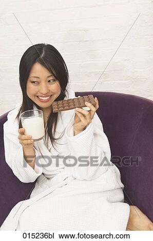 portrait of young japanese woman drinking milk and eating chocolate View Large Photo Image Stock Image - portrait of young japanese woman drinking milk and eating chocolate. Fotosearch