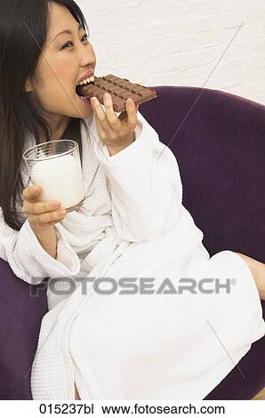 portrait of young japanese woman drinking milk and eating chocolate View Large Photo Image Stock Image - portrait of young japanese woman drinking milk and eating chocolate. Fotosearch
