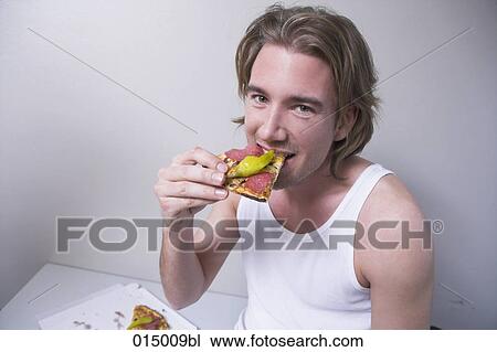 portrait of young man in undershirt eating piece of pizza View Large Photo Image Stock Image - portrait of young man in undershirt eating piece of pizza. Fotosearch