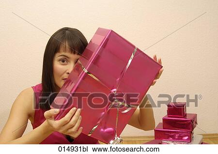 portrait of young woman holding christmas present View Large Photo Image Stock Image - portrait of young woman holding christmas present. Fotosearch