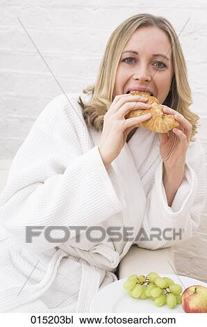portrait of young woman in white bathrobe having breakfast View Large Photo Image Stock Image - portrait of young woman in white bathrobe having breakfast. Fotosearch