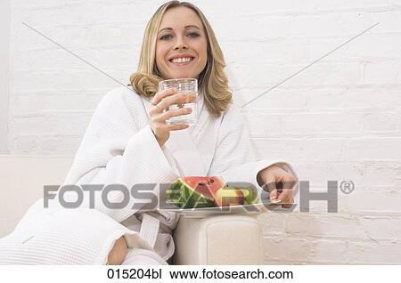 portrait of young woman in white bathrobe enjoying healthy breakfast View Large Photo Image Stock Image - portrait of young woman in white bathrobe enjoying healthy breakfast. Fotosearch