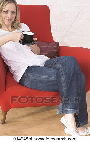 portrait of young woman relaxing on armchair drinking cup of coffee View Large Photo Image Stock Image - portrait of young woman relaxing on armchair drinking cup of coffee. Fotosearch