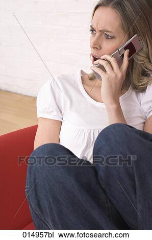 portrait of young woman relaxing on armchair and talking on mobile phone View Large Photo Image Stock Image - portrait of young woman relaxing on armchair and talking on mobile phone. Fotosearch