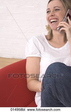 portrait of young woman relaxing on armchair and talking on mobile phone View Large Photo Image Stock Image - portrait of young woman relaxing on armchair and talking on mobile phone. Fotosearch
