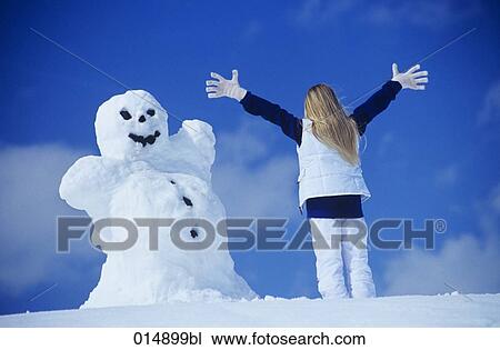 rear view of woman in front of snowman View Large Photo Image Stock Image - rear view of woman in front of snowman. Fotosearch