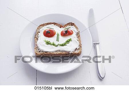 sandwich with cream cheese and face formed from chives and tomatoes View Large Photo Image Stock Image - sandwich with cream cheese and face formed from chives and tomatoes. Fotosearch