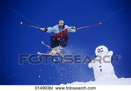 skier jumping with snowman in background View Large Photo Image Stock Image - skier jumping with snowman in background. Fotosearch