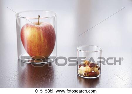 still life of apple and capsules in jars View Large Photo Image Stock Image - still life of apple and capsules in jars. Fotosearch