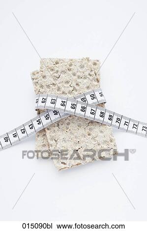 still life of crisp bread with tape measure View Large Photo Image Stock Image - still life of crisp bread with tape measure. Fotosearch
