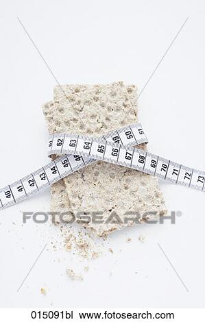 Stock Image - still life of crisp bread with tape measure. Fotosearch