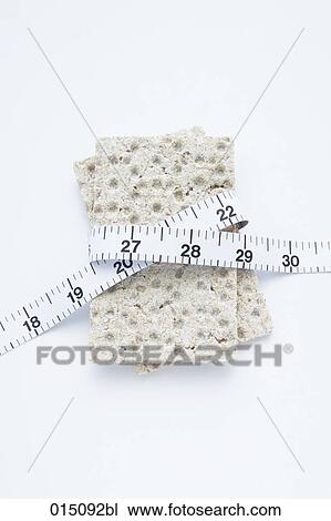 Stock Image - still life of crisp bread with tape measure. Fotosearch