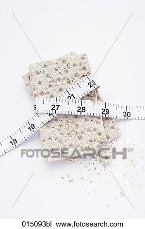 still life of crisp bread with tape measure View Large Photo Image Stock Image - still life of crisp bread with tape measure. Fotosearch