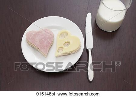 still life of ham and cheese sandwich cut out in shape of heart on plate and glass of milk View Large Photo Image Stock Image - still life of ham and cheese sandwich cut out in shape of heart on plate and glass of milk. Fotosearch