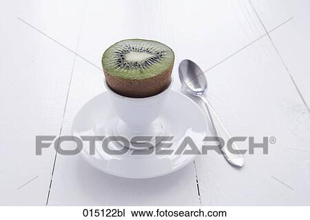 Stock Image - still life of kiwi fruit in eggcup. Fotosearch