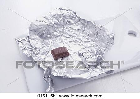 still life of piece of chocolate wrapped on aluminium foil View Large Photo Image Stock Image - still life of piece of chocolate wrapped on aluminium foil. Fotosearch