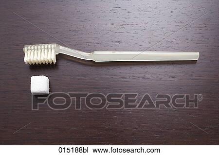 Stock Image - still life of toothbrush and sugar cube. Fotosearch