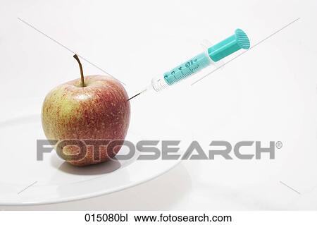 syringe injecting red apple lying on plate View Large Photo Image Stock Image - syringe injecting red apple lying on plate. Fotosearch