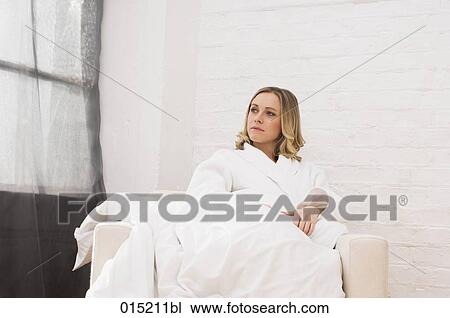 thoughtful young woman sitting alone in arm chair View Large Photo Image Stock Image - thoughtful young woman sitting alone in arm chair. Fotosearch