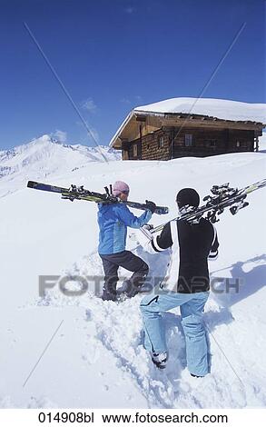 two skiers walking towards alpine hut on mountain View Large Photo Image Stock Image - two skiers walking towards alpine hut on mountain. Fotosearch