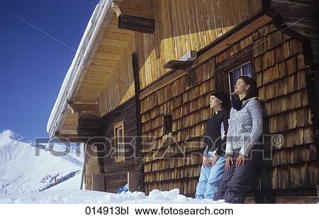 two young woman sunbathing near alpine hut View Large Photo Image Stock Image - two young woman sunbathing near alpine hut. Fotosearch