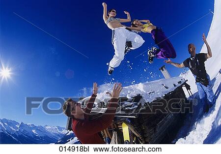 two young women in bikini tops jumping from roof of alpine hut in winter View Large Photo Image Stock Image - two young women in bikini tops jumping from roof of alpine hut in winter. Fotosearch