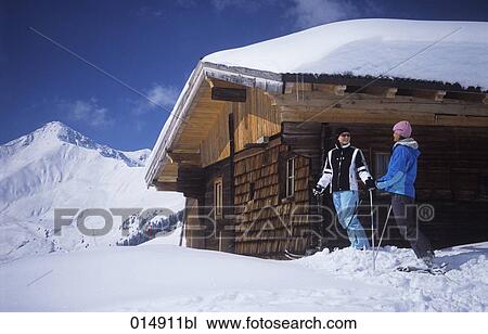 two young women on skis at alpine hut View Large Photo Image Stock Image - two young women on skis at alpine hut. Fotosearch