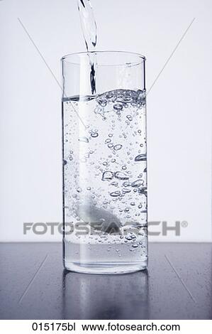 water being poured into glass with tablet View Large Photo Image Stock Image - water being poured into glass with tablet. Fotosearch