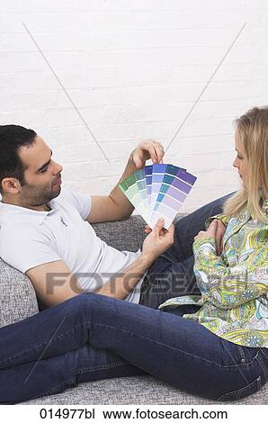 young couple on armchair choosing colour from colour chart View Large Photo Image Stock Image - young couple on armchair choosing colour from colour chart. Fotosearch