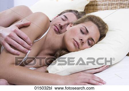 young couple sleeping in bed together man holding woman View Large Photo Image Stock Image - young couple sleeping in bed together man holding woman. Fotosearch